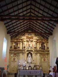 Iglesia parroquial de El Valle (construida en torno a la fachada-retablo donde inicialmente se celebraban los ritos al aire libre).