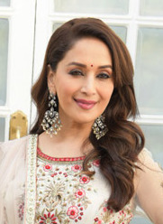 Madhuri Dixit is smiling at the camera.