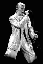 A black-and-white photo of Bowie singing
