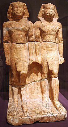 Duo of''' statues representing the king as a young and old man, standing with a sword