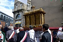 Des hommes portent un reliquaire en or sur leurs épaules lors d'une procession