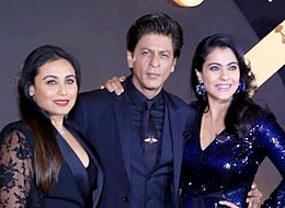 Rani Mukerji, Shah Rukh Khan, and Kajol pose for the camera.