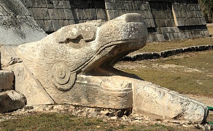 A feathered serpent sculpture at the base of one of the stairways of Kukulcán (El Castillo)