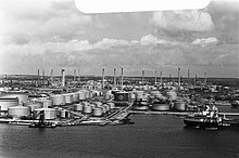 Refinery with several tanks and a bay in the foreground