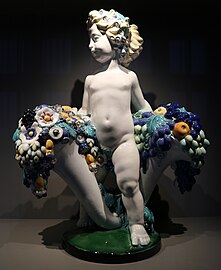 Austrian Art Nouveau - Putto with two cornucopias with floral cascades, by Michael Powolny, designed in c.1907, produced in 1912, ceramic, Kunstgewerbemuseum Berlin, Berlin, Germany[69]