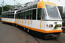 Two-car, white-and-orange tram