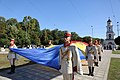 Members of the company holding a large Flag of Moldova.