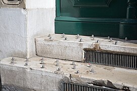 Hostile architecture: bolts installed on the front steps of a building to discourage sitting and sleeping