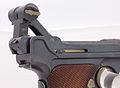 Swiss Parabellum Model 1900 Luger with breech opened, showing the jointed, toggle, locking arm in its most bent position.