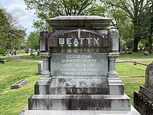A large headstone reading "BEATTY" in all caps with the names of the subject and his wife, and the birth and death dates of both persons.