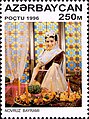 Novruz commemorative stamp, depicting a woman at a holiday table lit with candles