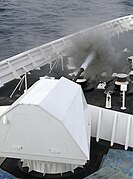 The Mk 110 aboard the Bertholf firing during Combat System Ship Qualification Trials