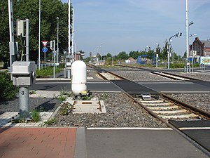 Level crossing in Germany with an egg-shaped radar sensor for detecting obstacles on the crossing