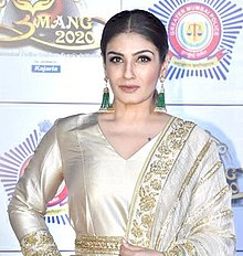 A picture of Raveena Tandon looking forward, smiling and posing for the camera