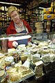 A counter sales assistant in a delicatessen offers taste tests and provides expert advice on products and uses