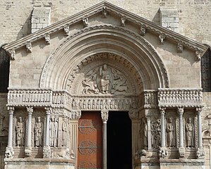 The Basilica of Saint-Trophime, Arles, France, has an elaborate sculptural scheme which includes Christ in Majesty, a frieze extending over the lintel and a gallery of sculptured figures.