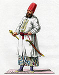 Osmansk mamelukk i Egypt i 1779, iført vanlig krigerdrakt med vide bukser, sid jakke og høy fess.