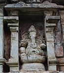 Ganesha, son of Parvati and Shiva, with a pen and sweetmeat food in his hands.