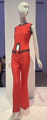 Same two-piece red outfit as in lead image, but from the front. Coins are attached to the hem of the top as decoration.