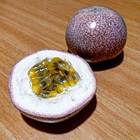 A ripe passion fruit, cut in half to show the insides