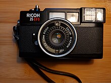 This photo depicts a black Ricoh 35 EFS film camera
