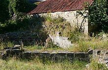 Stone foundations in front of a wall
