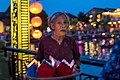 An old woman releases water lanterns in Hội An