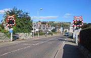 An open level crossing with warning lights and signs known as an AOCL in Dingwall, Highland