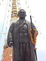 King Rama III sculpture standing in front of a chedi