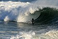 Shoreline wave-breaking (surf); Human riding surfboard.