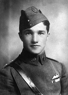 Head-and-shoulders portrait of young dark-haired man in military uniform wearing forage cap