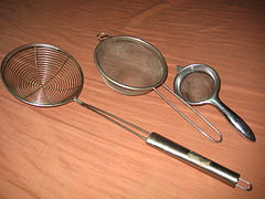 Several wire meshes shaped like bowls, with metal handles.