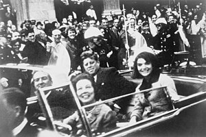 John F. Kennedy kun la edzino Jacqueline (dekstre) kaj teksasa guberniestro John Connally kun la edzino Nellie mallongtempe antaŭ la atenco