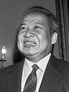 Sihanouk smiling in a black-and-white photograph