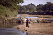 Girls crossing a river (Zambia)