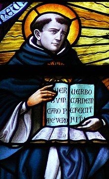 A stained glass image of Thomas Aquinas holding a book with an excerpt from the Pange lingua.