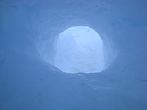 Interior of an igloo, facing the passageway leading to the entrance