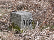 An East German boundary stone with the letters "DDR" (Deutsche Demokratische Republik) carved on the western-facing edge