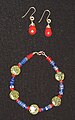 Necklace and earring set made from semiprecious stones. The spherical green beads are Russian serpentine. Also used are jasper (red) and fluorite (blue).