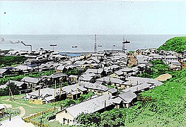 Shana Village in Etorofu (Shōwa period). There is a village hospital in the front, a factory in the left back with a fishery and a central radio tower (before 1945).
