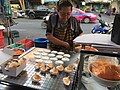 Mae ka (แม่ค้า; female trader in Thai) is cooking Khanom buang at Tha Din Daeng