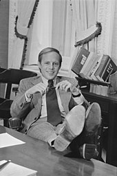 Casual portrait of John Dean sitting in his office with his feet on the desk