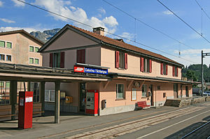 Two-story building with gabled roof next to railway lines