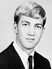 1964 high school senior photo portrait of Lynch in a suit