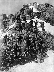 B&W photo of men in the Alpine