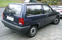 Rear-three quarter view of a small three-door car with flush headlamps.