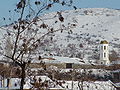 Зимен изглед към църквата от селото