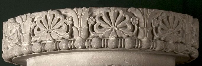 Frieze of the lost capital of the Allahabad pillar, with two lotuses framing a "flame palmette" surrounded by small rosette flowers, over a band of bead and reel, 3rd century BC, unknown material, Allahabad Museum, Prayagraj, India