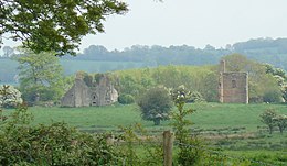 The ruins of Tristernagh Abbey seen from a distance, with part of a Georgian house built on the site to the right