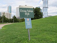 Sign marking Doug Sahm Hill with the Independent building seen in the background
